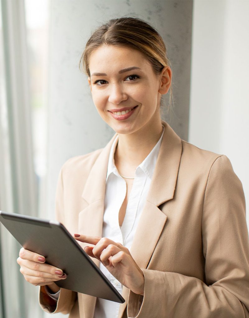 young-woman-holding-digital-tablet-in-modern-offic-MDR8BDP-1.jpg